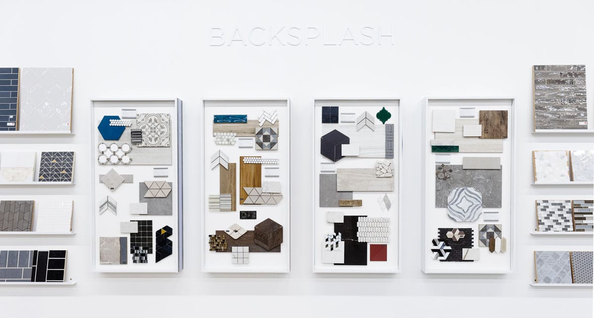 Four vertically oriented display boards showcasing a curated collection of design materials and textures in various patterns, colors, and shapes. The boards feature samples of tiles, wood finishes, geometric designs, and fabrics, arranged aesthetically for inspiration.